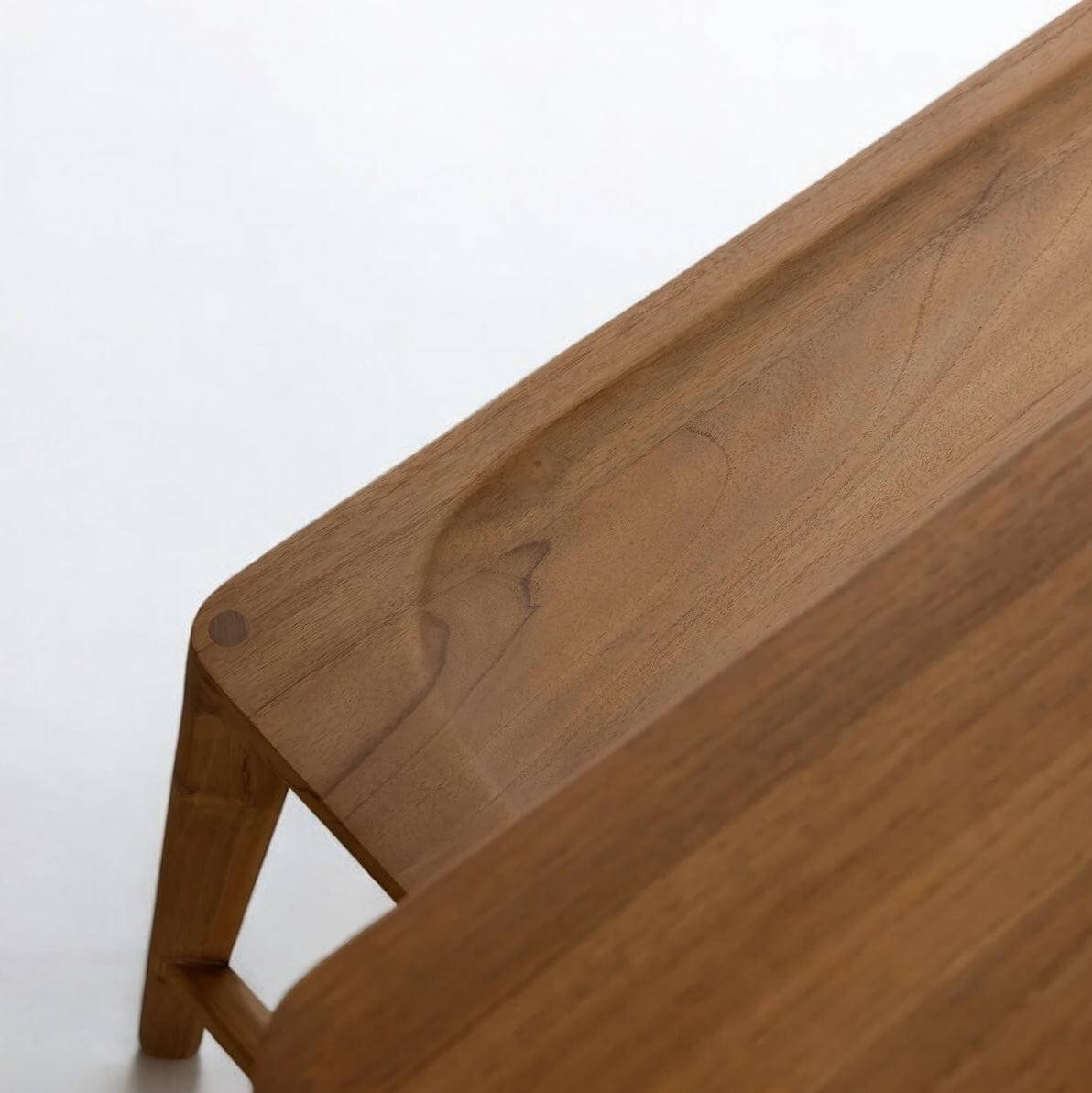 Close-up of the Glide Dining Bench made from recycled teak, showcasing its elegant grain and sustainable design.