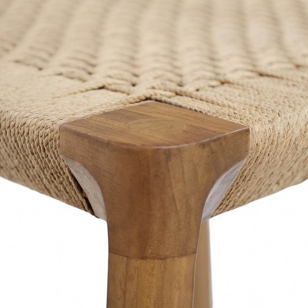 Close-up of the woven natural loom seat and teak leg of a stylish dining chair.