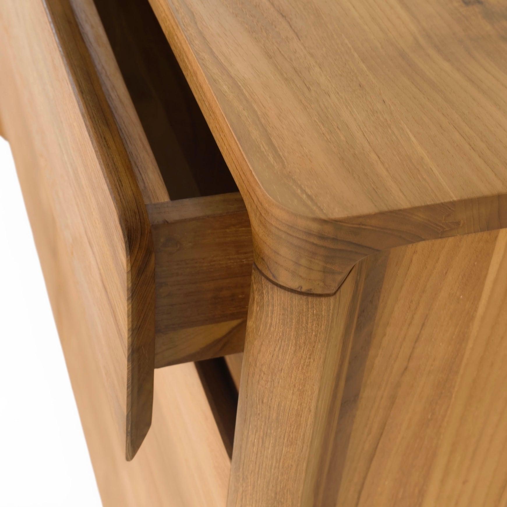 Close-up of a Glide solid teak buffet top and drawer, with a focus on the corner