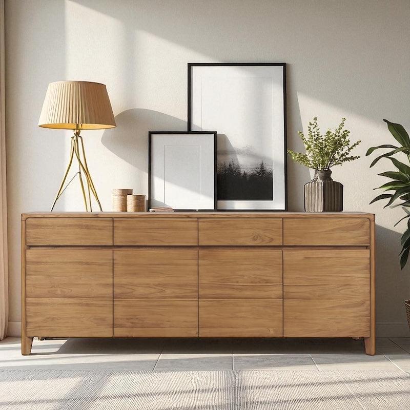Reclaimed teak sideboard with decorative items in a room with light-colored walls and a plant.