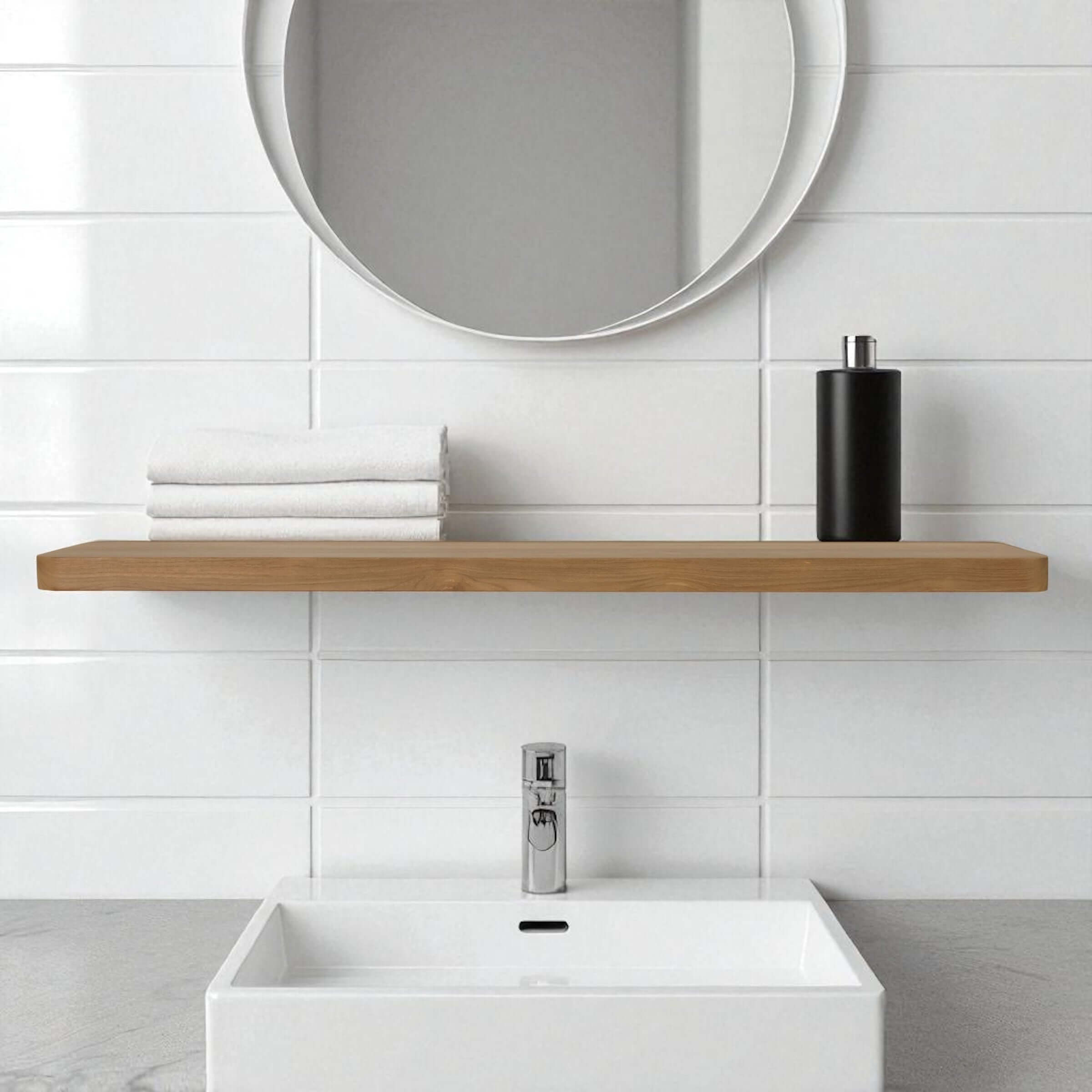 Reclaimed teak floating wall shelf above a white sink and towels in a modern bathroom setting.
