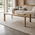 Modern living room with a wooden coffee table and beige sofa.